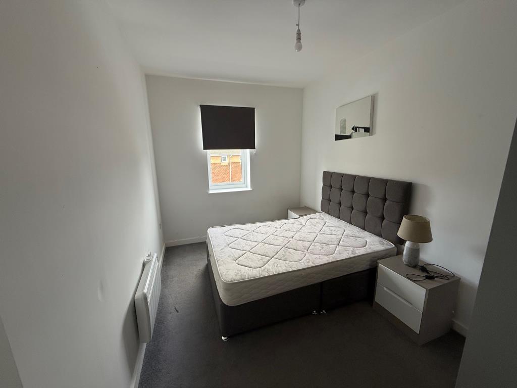 Lot: 128 - FLAT FOR INVESTMENT - Bedroom with white painted walls and grey flooring